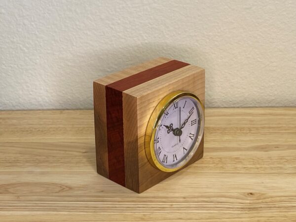 Curly Cube Clock: a small handmade wood clock from the Pacific Northwest, made from exquisite hand-selected hardwoods, a rustic modern, unique gift for any décor, holiday, or occasion. Roman numeral design with reliable quartz movement. Side view.