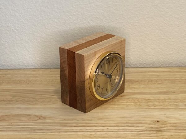Curly Cube Clock: a small handmade wood clock from the Pacific Northwest, made from exquisite hand-selected hardwoods, a rustic modern, unique gift for any décor, holiday, or occasion. Arabic numeral design with reliable quartz movement. Side view.